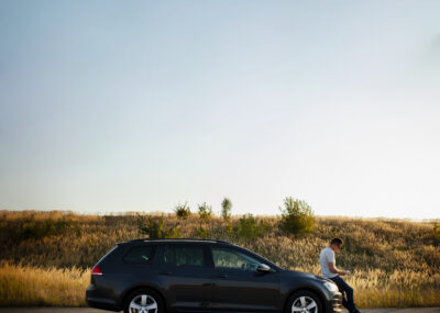 man-sitting-car-hood