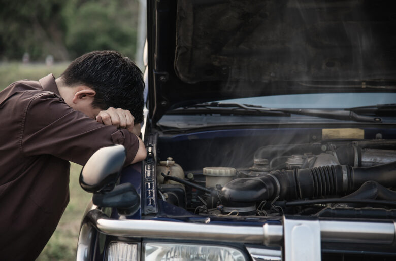 man-try-fix-car-engine-problem-local-road