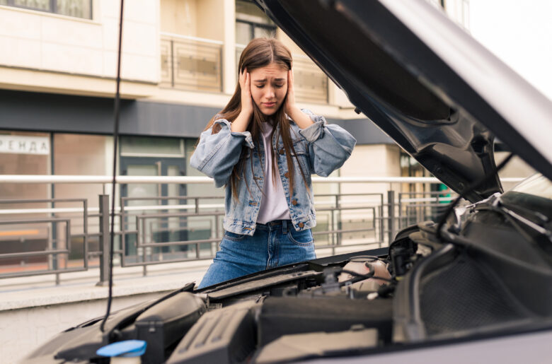 Young worried girl of the mechanic the problem with a car